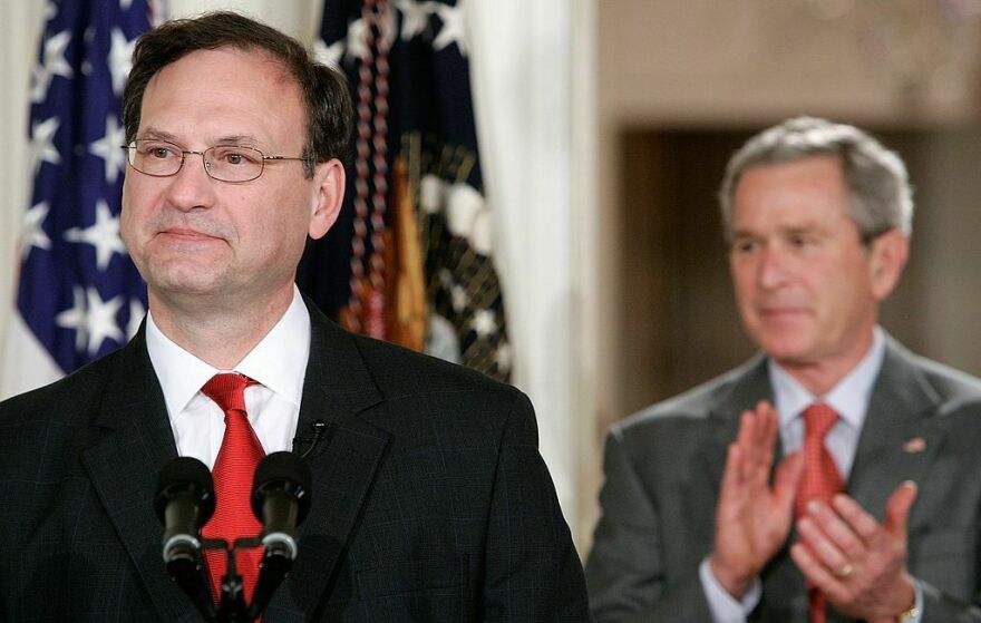 Then-President George W. Bush applauds as Justice Samuel Alito speaks during a ceremonial swearing-in at the White House in February 2006.