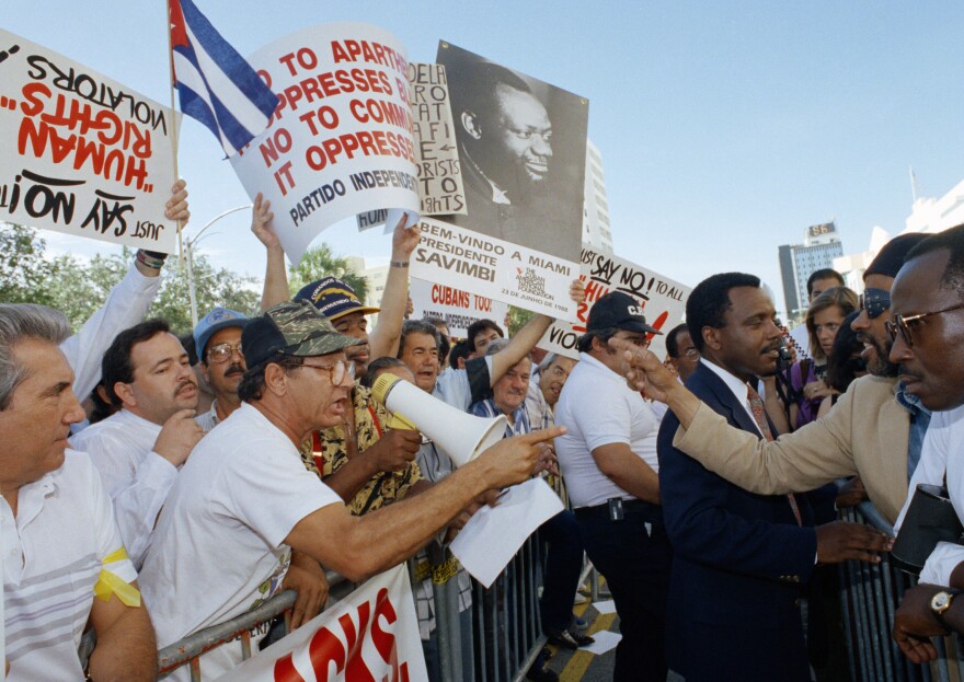 Pro Mandela supporters, right, clash with anti Castro Cuban exiles outside the Miami Beach Convention Center Thursday, June 28, 1990, while Nelson Mandela, Deputy President of the African National Congress was addressing the AFSCME International Convention.
