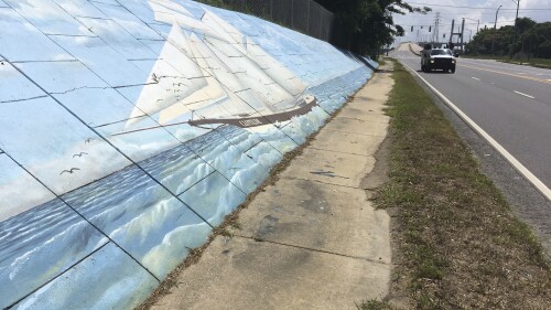 FILE - Traffic passes a mural along Africatown Boulevard in Mobile, Ala., May 30, 2019. A museum that opened in Mobile on Saturday, July 8, 2023, tells the story of the Clotilda, the last ship known to have brought enslaved people from Africa to the United States. (AP Photo/Kevin McGill, File)