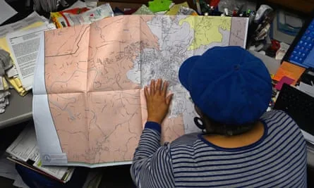 Election worker Vanessa Waddell checks redistricting maps in Rome, Georgia