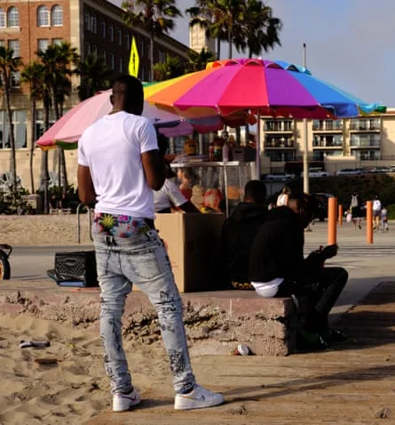 Men enjoying fresh fruit from the fruit cart at Santa Monica beach by the Hotel Casa del Mar
