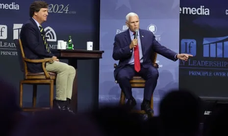 Mike Pence (right) answers questions from event host Tucker Carlson (left) in Des Moines today.