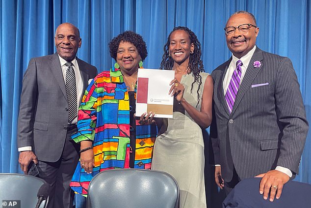 State Senator Steven Bradford, Secretary of State Shirley Weber, task force member Lisa Holder and Assemblymember Reggie Jones-Sawyer hold up a final report of the California Task Force to Study and Develop Reparation Proposals for African Americans during a hearing in Sacramento, California on Thursday