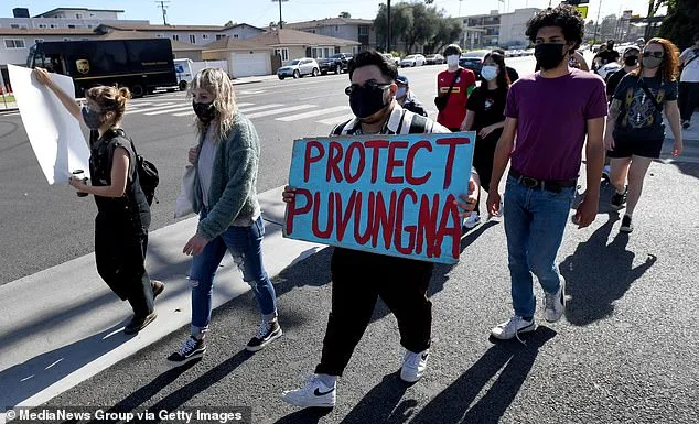 Native American groups are joining the movement to demand reparations after numerous tribes had their land taken by 'land-grab universities and colleges'. Pictured, a group of Native American activists and supporters march in Long Beach to support efforts to protect Puvungna land at California State University Long Beach (file photo from May 2021)