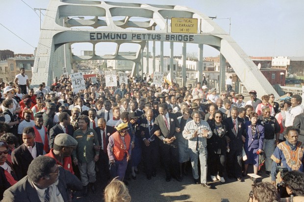 Thousands of demonstrators, led by Georgia Congressman John Lewis, Jesse Jackson, and other civil rights leaders march across the Edmund Pattus Bridge in Selma on March 4, 1990. It marks the 25th anniversary of the original Selma to Montgomery march in 1965.