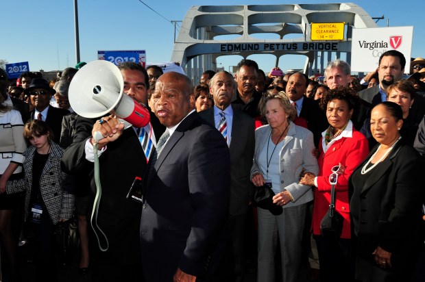 U.S. Rep. John Lewis, D-Ga., center, talks with those gathered on the historic Edmund Pettus Bridge in 2012 during the 19th annual reenactment of the 