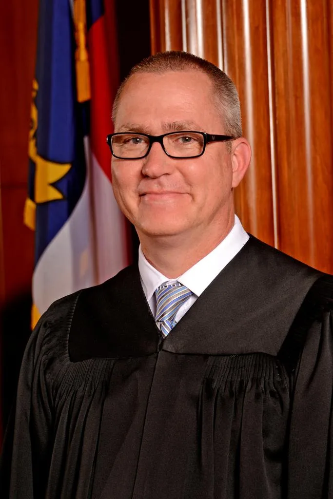 North Carolina Supreme Court Associate Justice Trey Allen poses in his judicial robe.
