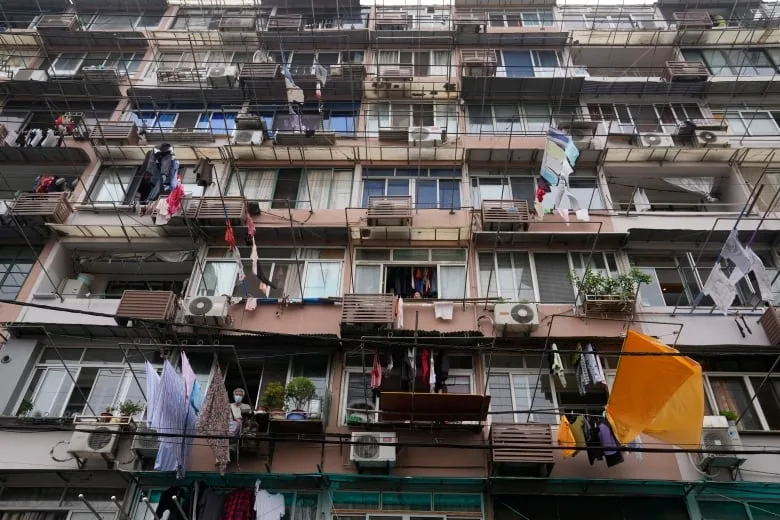 Laundry hangs from building