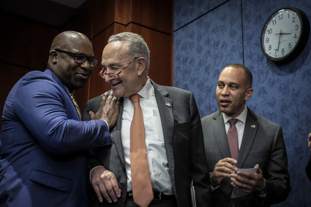 Jamaal Bowman, Chuck Schumer and Hakeem Jeffries attend a news conference.