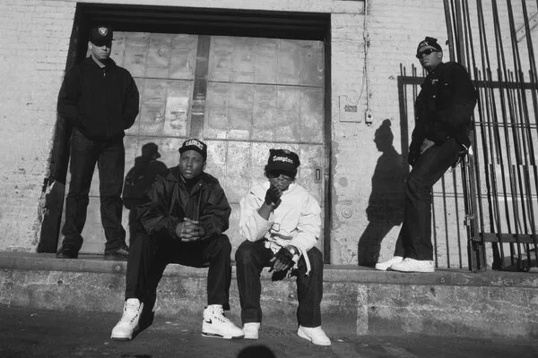 N.W.A. sitting or standing in front of a loading dock.