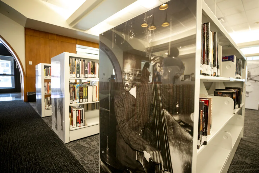 An image of Charlie Burrell on the side of a shelf in the Blair-Caldwell African American Research Library's main area. Aug. 10, 2023.