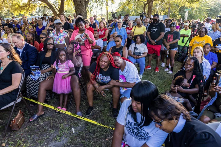 Trisha James, center, in black shirt, with Sabrina Rozier and Ieasia Gallion, 4, all relatives of Jacksonville shooting victim Jerrald De’Shaun Gallion of a deadly shooting that took place in Jacksonville, Fla. on Aug. 27, 2023. 