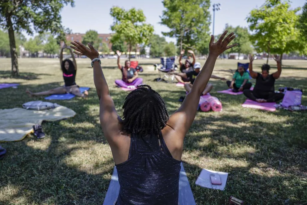 Sherkerra Smith leads a yoga self care event on June 24, 2023, in South Shore. Hosted by the Free Root Operation, the event is part of a series dedicated to investing in black mothers. 