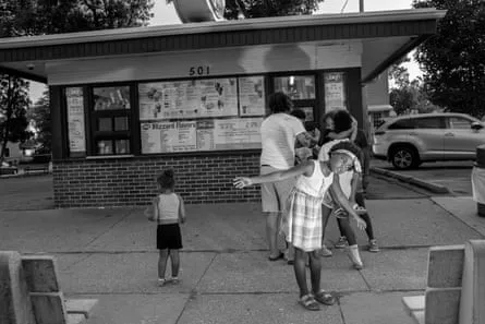 A family standing around outside at Dairy Queen 