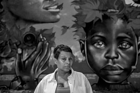 woman in front of a mural