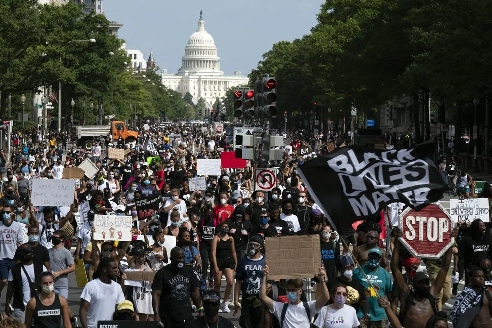 FILE - People walk along Pennsylvania Avenue during the March on Washington, Friday Aug. 28,...