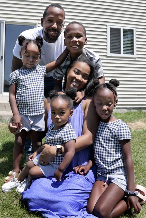 Shay Dunn, with her husband Riante Dunn, poses with their four children in the backyard of their home in Montgomery on July 10, 2023. After having a bad birthing experience, Dunn decided to give birth at home aided by a midwife who shared her racial identity and a family connection.