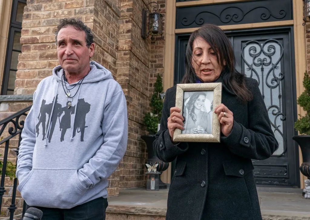 Phil and Cathie Vetrano talk about their daughter in front of their Howard Beach home.