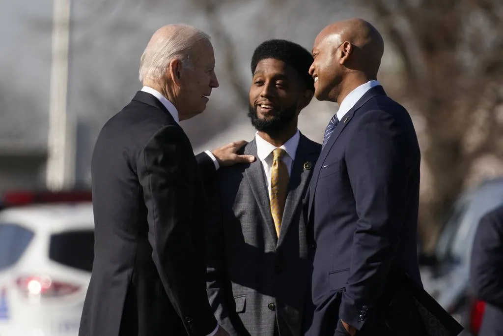 President Joe Biden greets Baltimore Mayor Brandon Scott, center, and Maryland Gov. Wes Moore on Jan. 30, 2023, before speaking about infrastructure at the Baltimore and Potomac Tunnel North Portal in Baltimore.