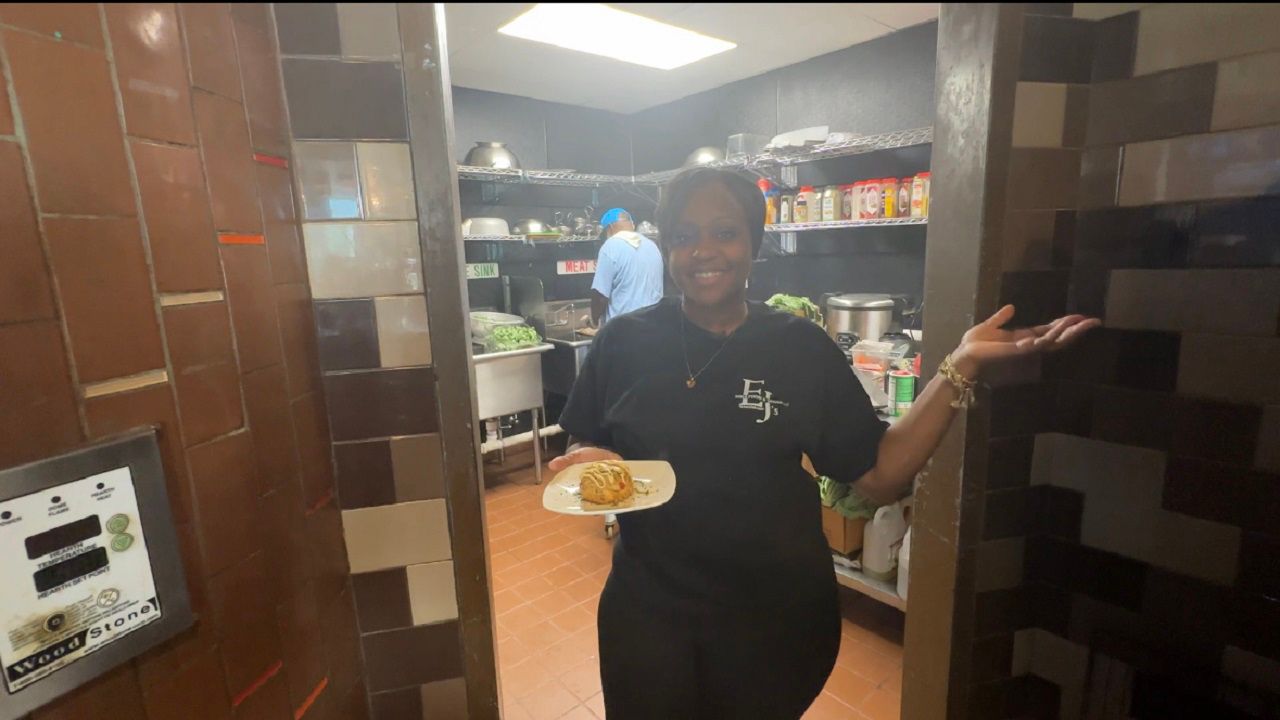 Restaurant owner Dara Bess is holding one of the vegan options, Krabby Cakes. Bess says EJ's Soul Food and Vegan is serving up items like this one, filled with love.