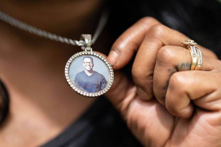 Rafiah Maxie-Cole, who founded Soul Survivors of Chicago after her son Jamal Clay died by suicide in 2020, shows her necklace with a photo of her son.