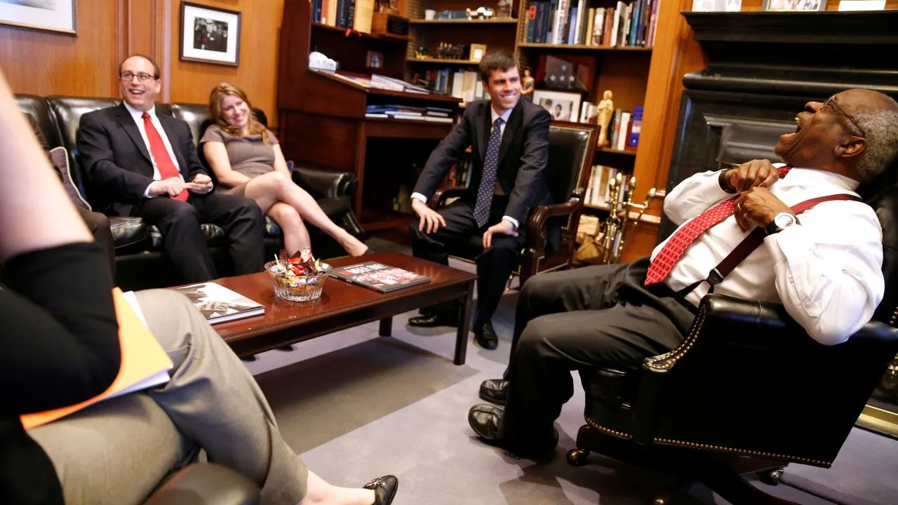 Supreme Court Justice Clarence Thomas jokes with his clerks as he describes their decision-making process in his chambers at the Supreme Court building in Washington, DC, in 2016.