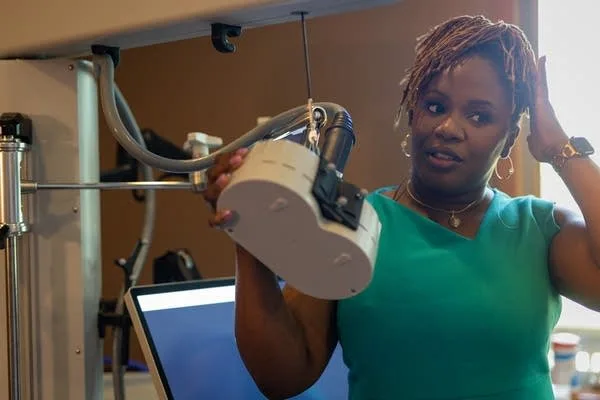 A woman demonstrates a large treatment machine