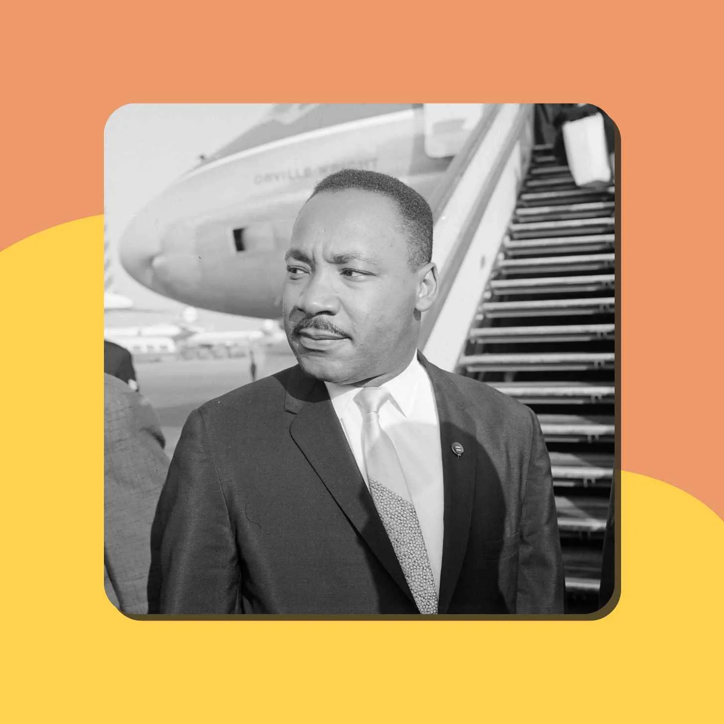 A Black And White Picture Of Martin Luther King Posing In Front Of A Plane