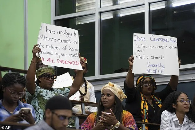 Charles Gladstone's speech was interrupted by protesters holding up placards at the back of the room