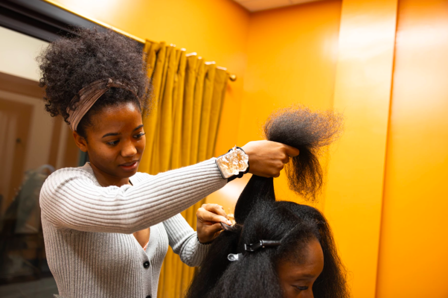 Stylist Aliyah Hale talks to La Toya Gadson while braiding her hair at Braided by Liyah salon in Austin. 