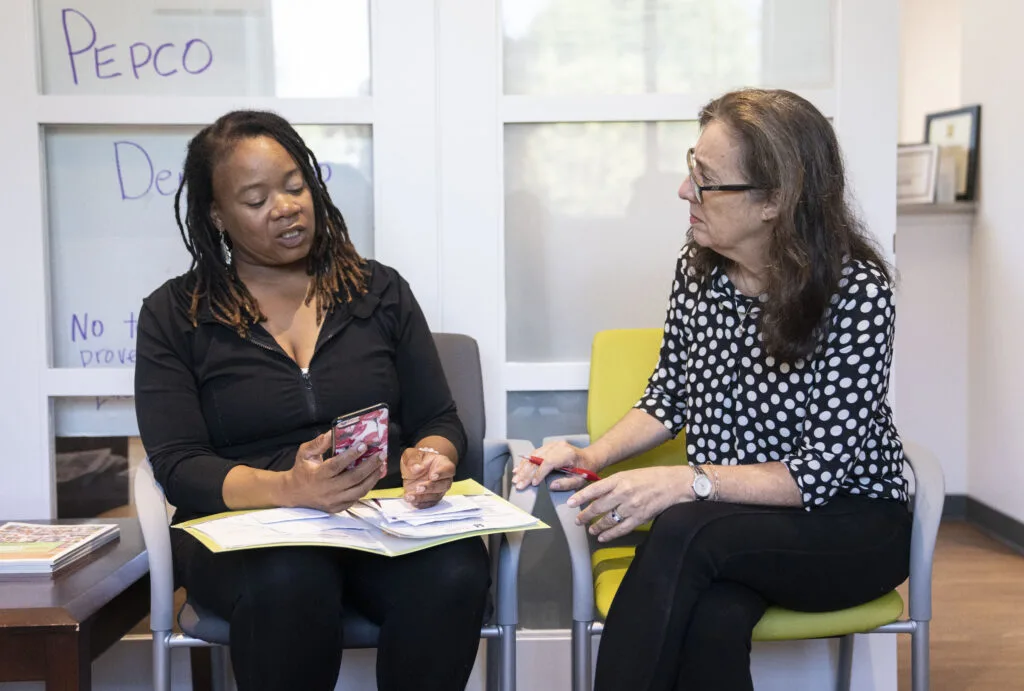 Stacy Smith, left, works with Cares volunteer Laurel Paltier at the GEDCO building in Baltimore, Wednesday, August 23, 2023. Credit: Jessica Gallagher / The Baltimore Banner