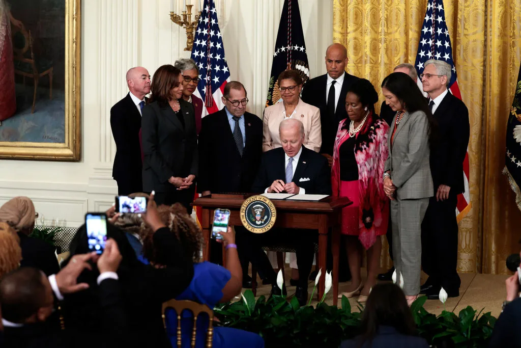 Flanked by U.S. Vice President Kamala Harris, lawmakers and cabinet members, U.S. President Joe Biden signs an executive order enacting further police reform in the East Room of the White House on May 25, 2022 in Washington, DC. President Biden's executive order is intends to improve police accountability and direct federal agencies to revise use-of-force policies, such as banning tactics like chokeholds.   (Anna Moneymaker-Getty Images)