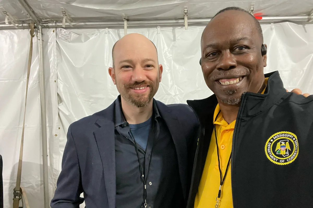 Lance Kramer (left) smiling and posing with Maurice Clifton Sr. (right) (The First Step)