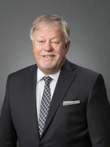 This is a photo of Lindsey Griffin, a member of lottery commission. He's a white man with graying hair, a mustache and a goatee. He's wearing a dark suit with a white shirt and black-and-white tie.