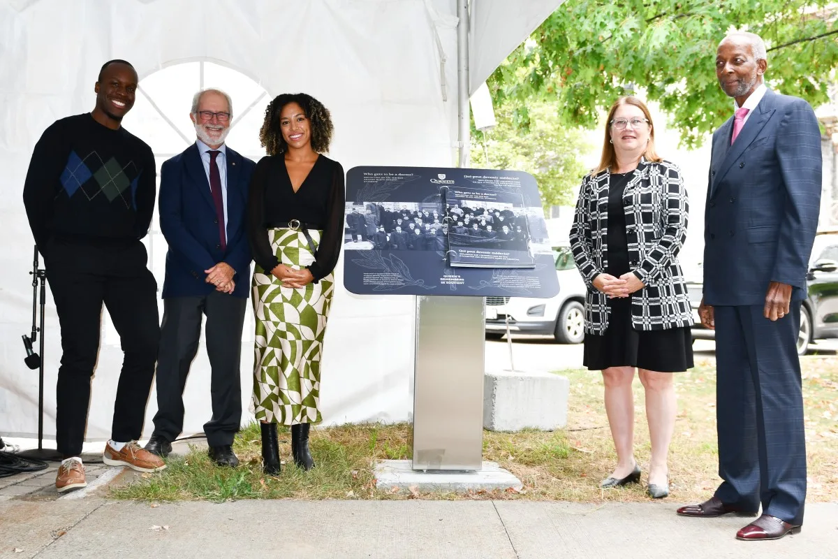 Photograph of the new Queen's Remembers plinth with attendees of the unveiling ceremony.