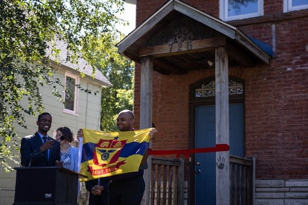 A man holds up a yellow flag