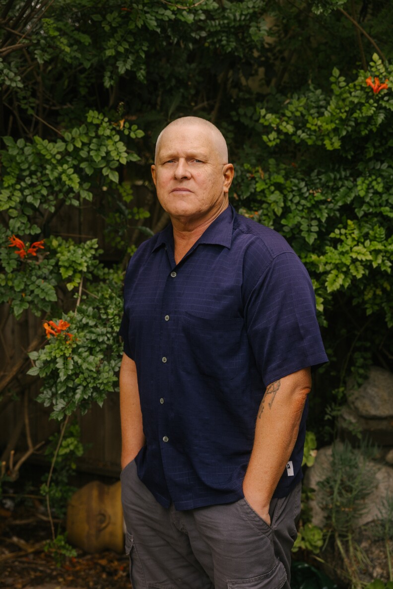 Former councilmember Mike Bonin, a bald man with light-brown skin tone, photographed in his home. 