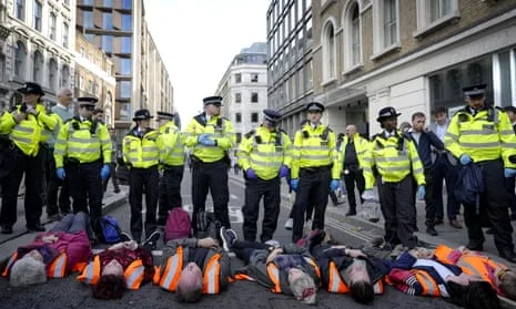 Handcuffed activists from the group Just Stop Oil lie on the road as they are arrested after they blocked a road in London in October 2022.