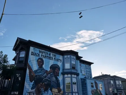 painting on side of house shows five women