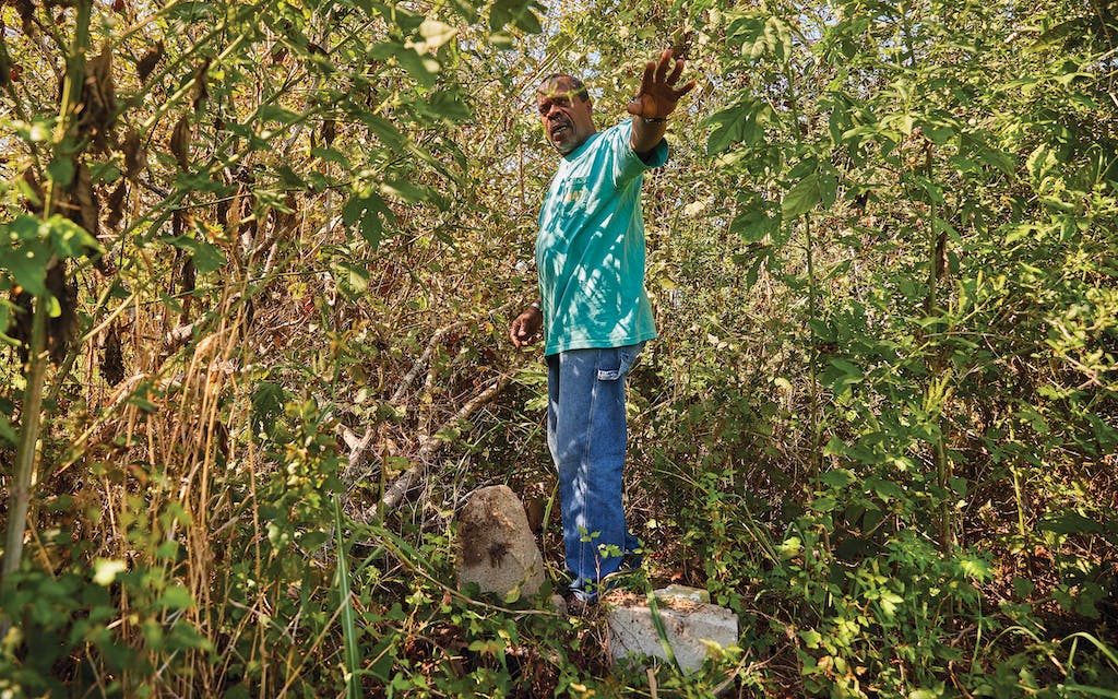 Brad Smith searches for the remains of the cinderblock foundation of Brooks Chapel.