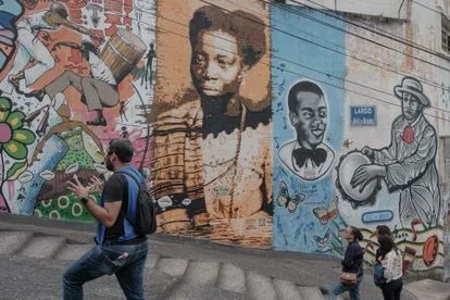 An African Heritage Walking Tour guide, explains the history of the Sun Stone in Rio de Janeiro