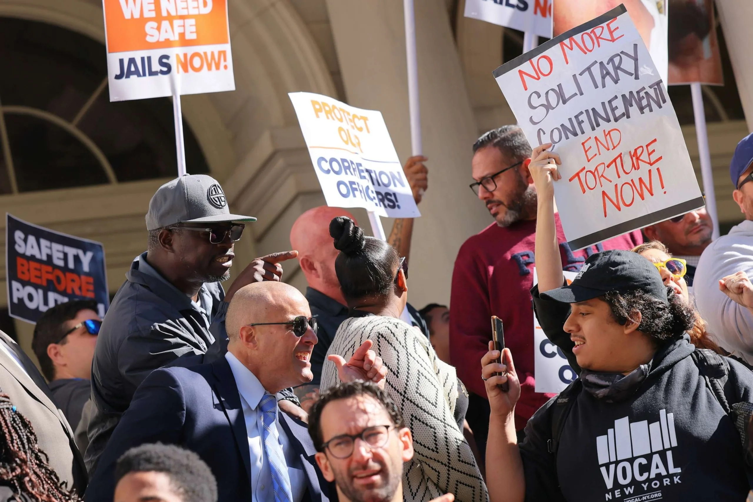PHOTO: NY Corrections officers and criminal justice reform activist exchange words during a rally outside of City Hall before the start of a City Council hearing on Intro 549, Sept. 28, 2022, in New York.
