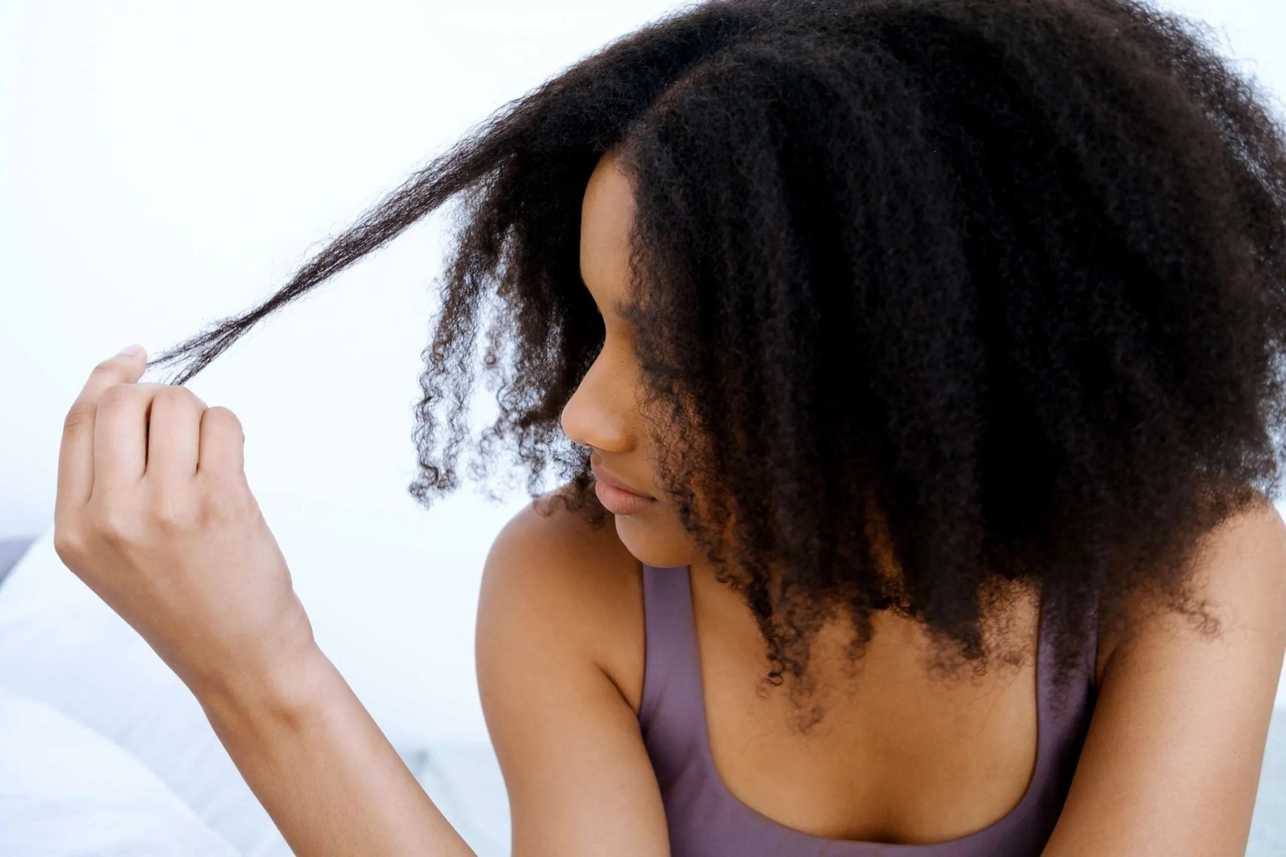 PHOTO: Stock photo of a woman looking at her hair.