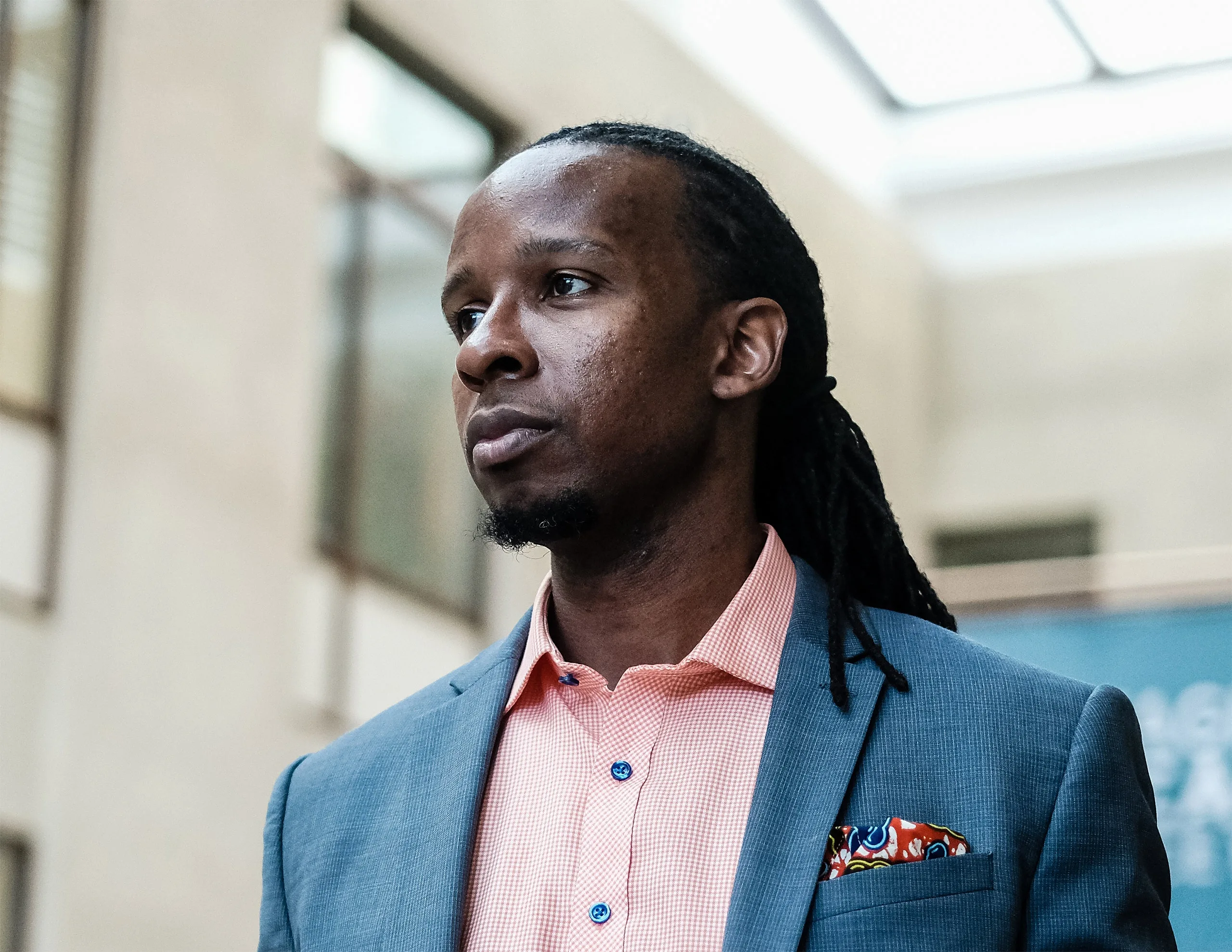 A portrait of the author Ibram X. Kendi who is wearing a suit.