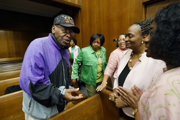 U.S. Air Force veteran and retired postal worker, James Robinson, 90, left, speaks with other attendees at a candidates forum, Oct. 26, 2023, in Vicksburg, Miss. (AP Photo/Rogelio V. Solis)