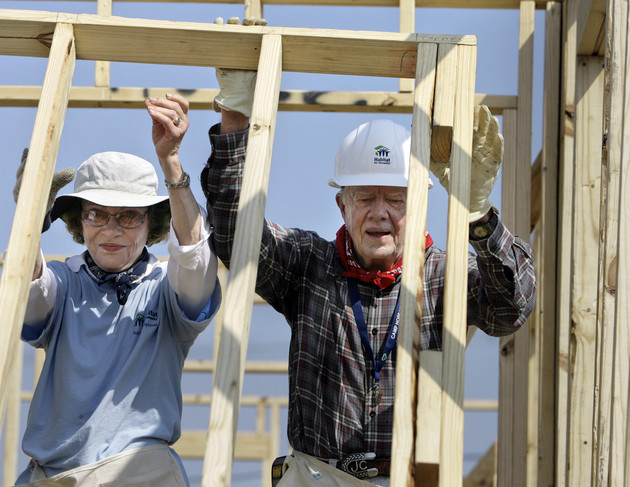 Jimmy Carter and Rosalynn Carter raise a wall as they help build a Habitat for Humanity house in Violet, Louisiana.