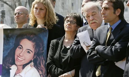 group of adults behind a poster of a young woman