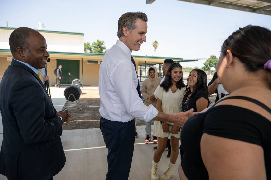 California Gov. Gavin Newsom greets students with state Superintendent of Public Instruction Tony Thurmond, left, at River City High School in West Sacramento on Thursday, Aug. 31, 2023. Thurmond is running to succeed Newsom in 2026.