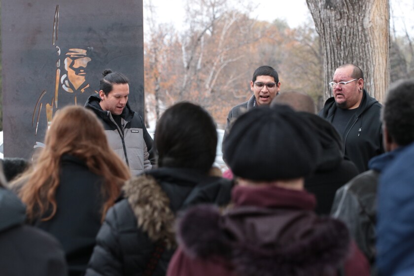 Left to right Stuart Lohnes, from Standing Rock, Montgomery Brown, from Spirit Lake, and Ethan Lohnes, also from Standing Rock, sang a Native prayer song at the unveiling of Felix Battles' memorial on Saturday, No.jpg