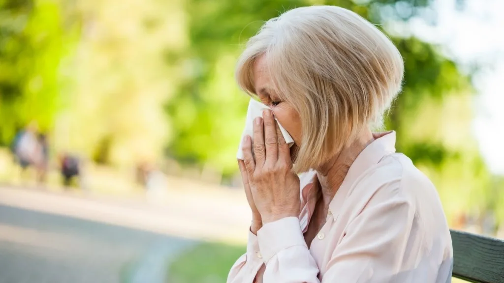 A woman with a tissue who has allergies